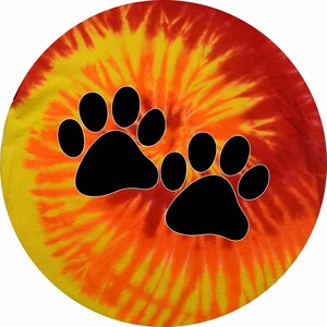 May include: A yellow, orange, and red tie-dye background with two black paw prints. The paw prints are centered on the background.
