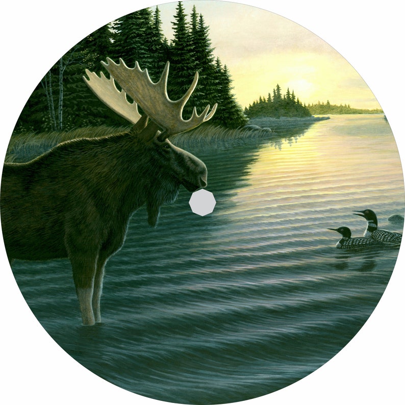 May include: A moose stands in a lake at sunset, looking at two loons swimming in the water. The moose is brown with large antlers. The loons are black and white with red eyes. The water is a deep blue with ripples. The sky is a soft orange and yellow.