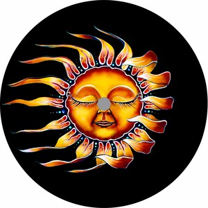 May include: A stylized illustration of a sun with a smiling face and closed eyes. The sun has a yellow face with orange and red rays. The background is black.