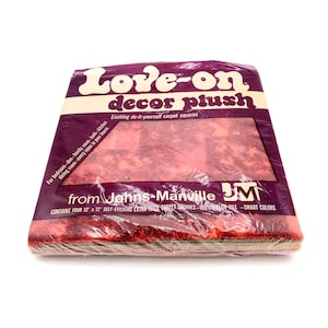 May include: A package of "Love-on decor plush" carpet squares. The package is purple with white and brown text. The text reads "Exciting do-it-yourself carpet squares" and "Contains four 12 x 12 self-sticking extra thick carpet squares".