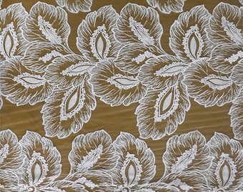 May include: White lace fabric with a floral pattern. The fabric has a delicate, intricate design with small, white beads.