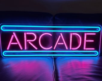 May include: A neon sign with a blue border and pink letters that reads "ARCADE".