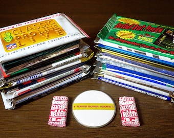 May include: A stack of unopened packs of 1993 Classic Pro Line NFL trading cards, a stack of unopened packs of Football Draft Preview trading cards, and two Bazooka bubble gum wrappers. A white round sticker with the text "TOPPS SUPER ROOKIE" is in the center of the image.