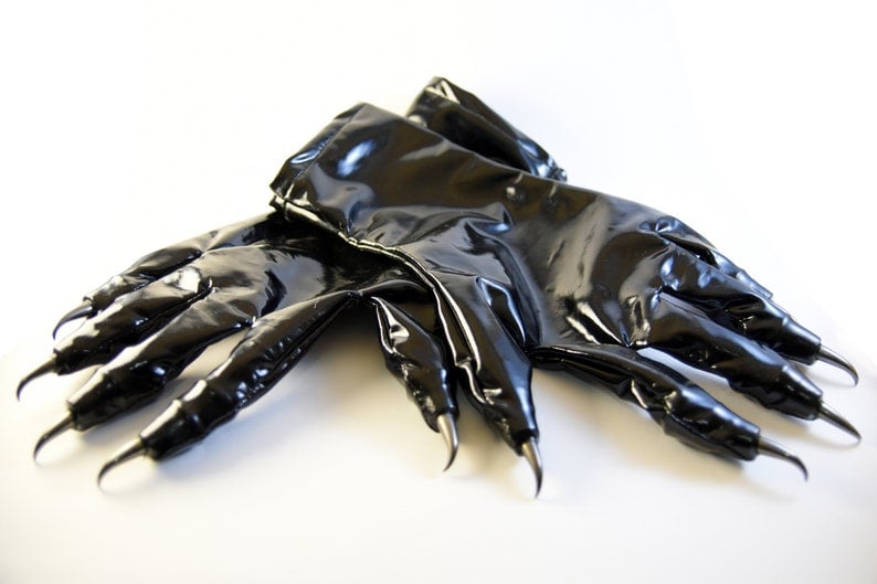 May include: A pair of black, shiny, long gloves with claw-like fingertips.