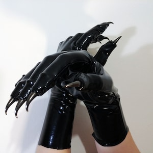 May include: A pair of long, black, shiny, latex gloves with sharp, silver claws on the fingertips.