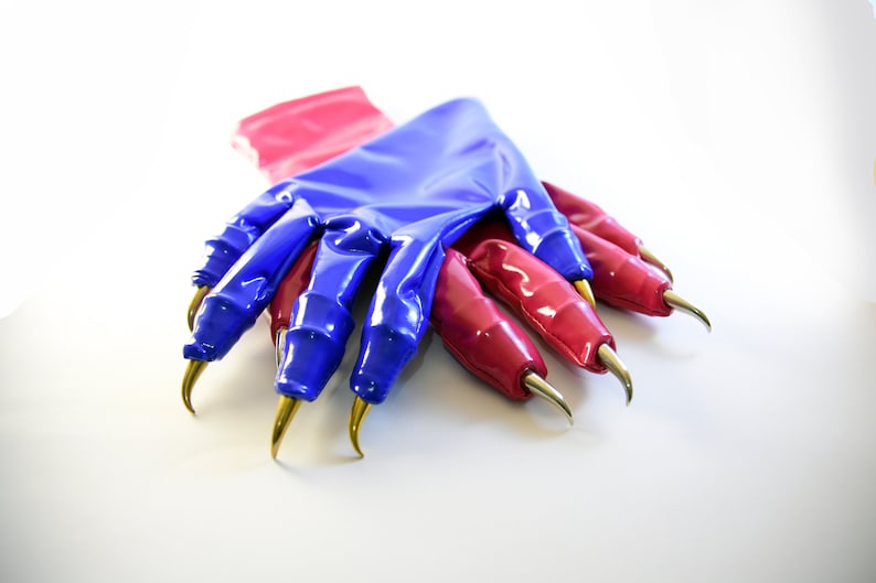May include: A pair of blue and pink latex gloves with long, sharp, gold claws. The gloves are folded over each other.