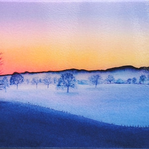 May include: A rectangular glass chopping board with a landscape painting. The artwork shows a sunrise over a field with trees and a fence. The sky transitions from purple to orange, with a blue foreground.