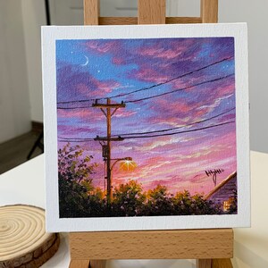May include: A painting of a sunset with a power line and a streetlight in the foreground. The sky is a mix of pink, purple, and blue with a crescent moon and stars.