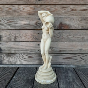 sculpture of female figure with vase