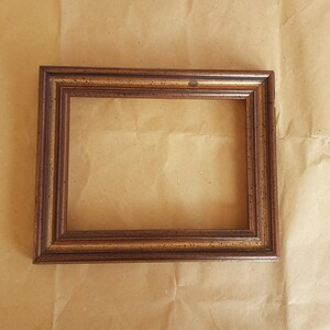 antique wooden frame decorated with gold leaf