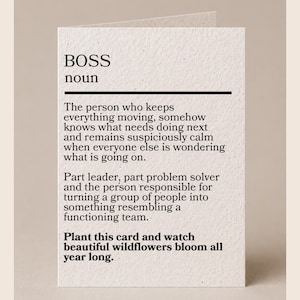 May include: A white textured greeting card featuring black printed text that defines the noun BOSS as a person who keeps everything moving, solves problems, and leads a team. The bottom of the card includes the instruction to plant the card.