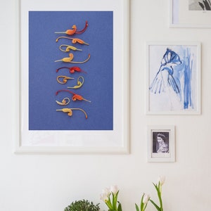 May include: A white shelf unit with three shelves. The top shelf has a wooden surface and is decorated with a potted plant, three vases with white flowers, and a blue glass bottle. The middle shelf has a white storage bin and a metal bin. The bottom shelf has a wooden crate.