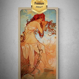 May include: A vintage art nouveau print depicting a woman with long flowing hair wearing a crown of red flowers. She is seated on a rock by a body of water with a lush green background. The print is in warm tones of yellow, orange, and green.