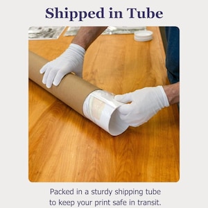 A person is packing a printed item in a sturdily packaged tube to keep it safe during transit.
