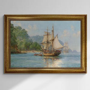May include: A framed nautical painting depicts a tall ship sailing on a calm sea. The artwork features a detailed depiction of the ship with billowing sails, set against a backdrop of a lush green shoreline and a clear blue sky. The frame is gold.