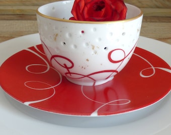 Porcelain candle holder with red ribbon and gold leaves