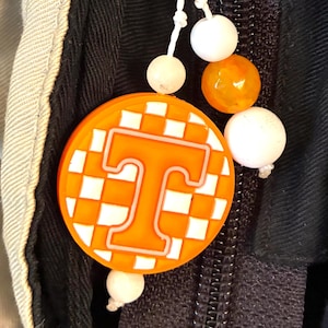 May include: A set of three ceramic mugs with a speckled, matte finish. The mugs are in shades of cream, light gray, and dark gray. Each mug has a simple, minimalist design, perfect for coffee or tea.