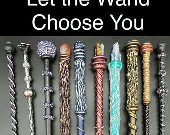 May include: A collection of ten decorative wands arranged in a row, each featuring unique textures, colors, and toppers like crystals or beads. The text 'Let the Wand Choose You' is displayed at the top of the image above the various wands.
