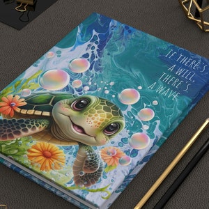 May include: A blue and green journal with a cartoon sea turtle swimming in a bubbly ocean. The journal has the text "If there's a will, there's a wave" on the cover.
