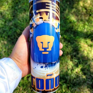 May include: A blue and orange tumbler with a graphic of a puma and the word "Tono" on it.