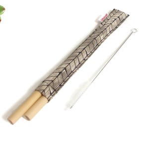 May include: Two brown bamboo straws with a gray and black patterned fabric carrying case and a silver cleaning brush.