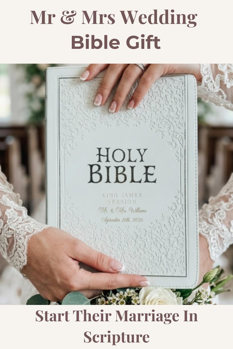May include: A white Holy Bible, King James Version, featuring an embossed floral border and personalized text reading Mr. & Mrs. Williams, September 26th, 2026. The cover has a textured finish with dark lettering for the title and light gold text.