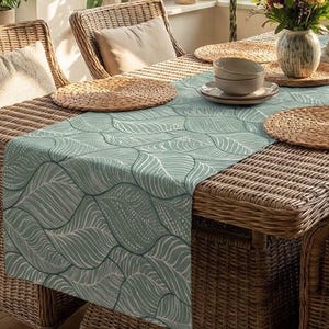 Sage green table runner "Fine Garden" with a fine linen-like texture, delicate leaf pattern in grey-green/reed, spring decoration