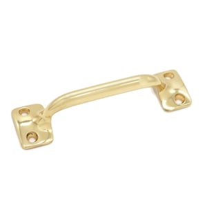 May include: A gold-toned metal pull handle with a curved design. The handle has two screw holes on each end.