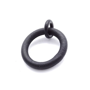 May include: A black metal ring with a smaller ring attached at the top. The ring has a textured surface and is set against a white background. The object appears to be a hardware component.