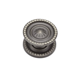 May include: A silver-toned cabinet knob with a beaded edge and a decorative center design.