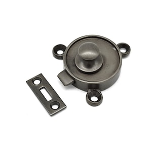 May include: A silver-toned, round, door latch with a knob. The latch has a rectangular strike plate.