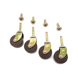 May include: Set of five brown rubber furniture casters with gold metal stems and mounting plates.