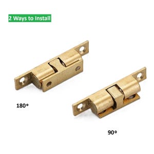 May include: Two brass-colored ball catches, each with two mounting plates and a central ball-and-socket mechanism. One is labeled "180°" and the other "90°". The text "2 Ways to Install" is in a green rectangle.