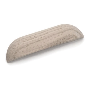 May include: A light gray wooden cabinet pull with a rounded shape. The pull is made of solid wood and has a smooth finish.