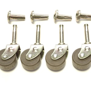 May include: Set of four brown rubber furniture casters with silver metal frames. Each caster has a threaded stem for attaching to furniture.