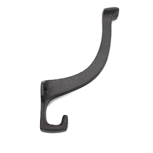 May include: A black cast iron hook with a curved design. The hook is designed to be mounted on a wall or other surface.