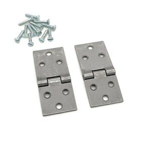 May include: Two silver metal hinges with six holes each and a rounded hinge pin. The hinges are on a white background with a pile of silver screws.
