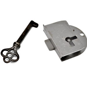 May include: A silver keyhole lock with a key. The key is made of metal and has a decorative design.