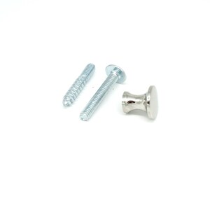 May include: A set of silver-toned cabinet hardware, including a small knob and two screws. The knob has a rounded top and a flared base. The screws are threaded, one with a pointed end and the other with a flat head.