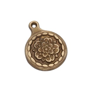 May include: A gold-toned metal pendant with a circular design featuring a detailed floral pattern.