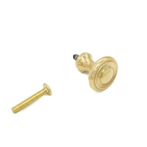 May include: A gold-toned cabinet knob with a round, fluted base and a screw.
