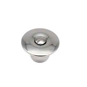 May include: A silver-toned, round, metal drain cover with a screw in the center.