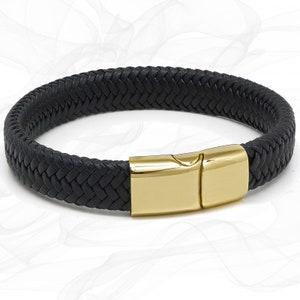 May include: A black leather braided bracelet with a gold-tone clasp.