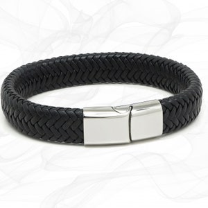 May include: A black leather bracelet with a silver clasp. The bracelet is braided and has a woven pattern.