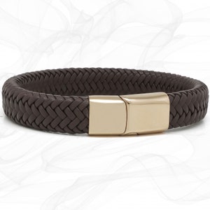 May include: A brown leather bracelet with a gold-tone magnetic clasp. The bracelet is braided and has a woven design.