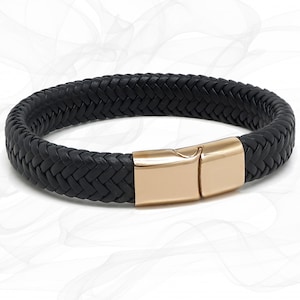 May include: A black leather braided bracelet with a rose gold clasp.