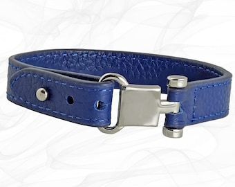 May include: A blue leather bracelet with a silver clasp. The bracelet has a stitched edge and a small silver rivet.