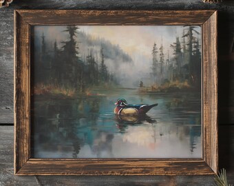 May include: A framed painting of a wood duck swimming in a lake, surrounded by a forest. The artwork features a rustic, brown wooden frame. The painting depicts a serene landscape with a misty background and a colorful duck.