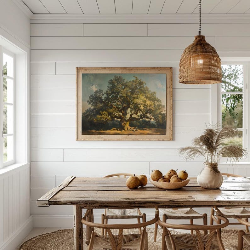 May include: A rustic wooden dining table with a light wood finish, set with a bowl of pears and a wicker pendant light hanging above. The table is surrounded by woven chairs and a rug.