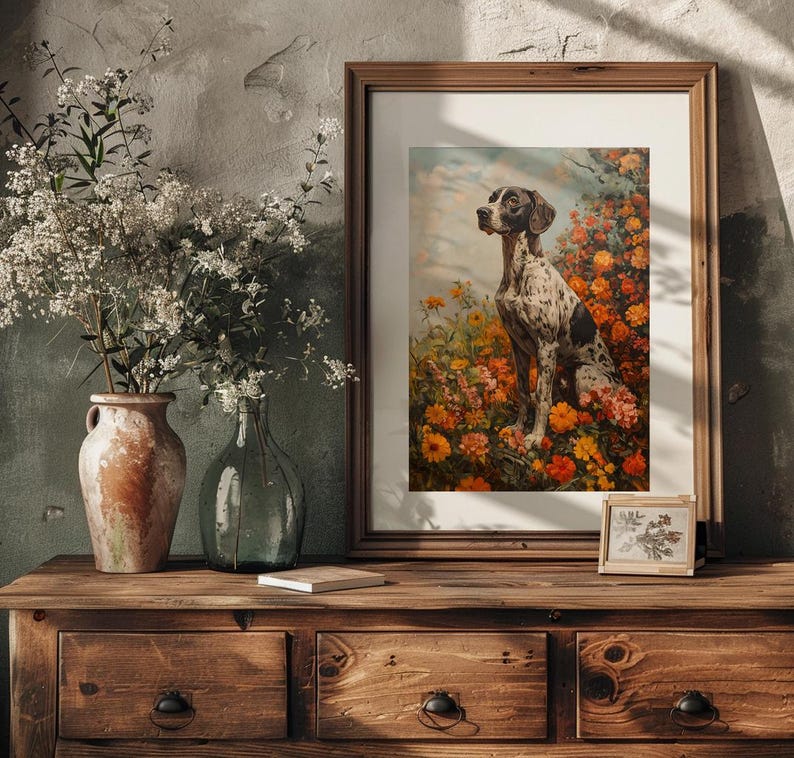 May include: A framed print of a black and white dog sitting in a field of orange and yellow flowers. The dog is looking to the left of the image.